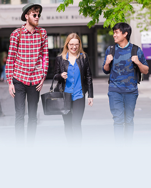 Three students walking outside ACU Melbourne Campus.