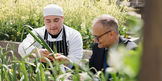 Brendan Watson and student explore the kitchen garden