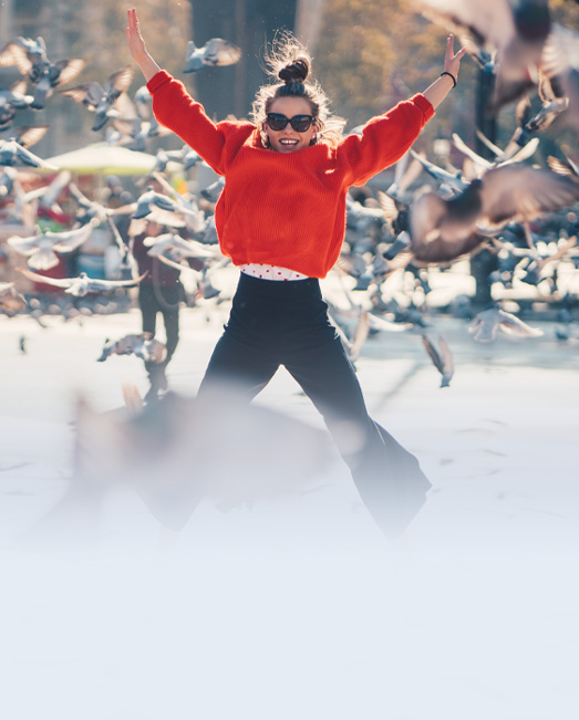 Teen leaping for joy with birds