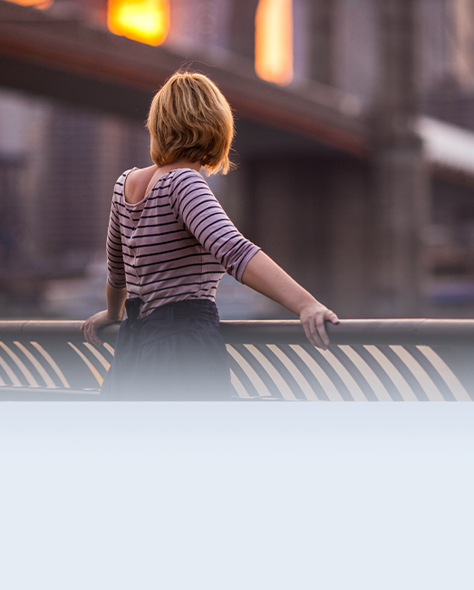 Girl watching the sunset over Brooklyn bridge