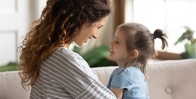 Mother and child smiling at each other