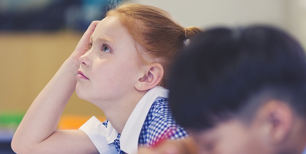 Schoolgirl frustrated at desk