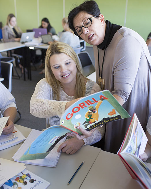 Teaching student and lecturer read a picture book