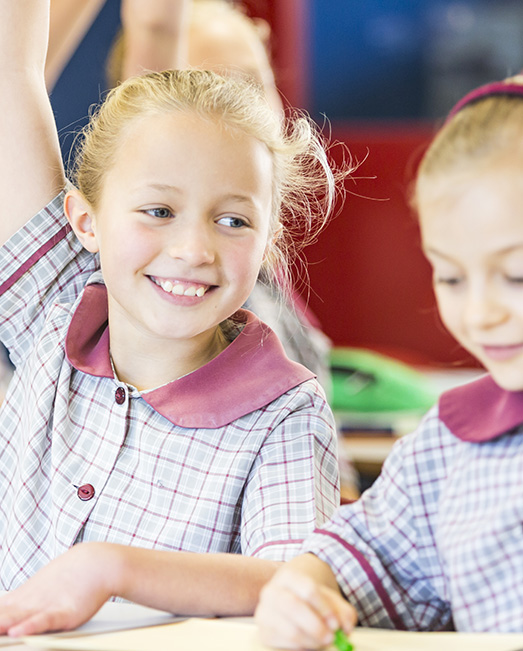 Primary school student raising her hand.