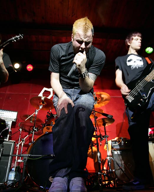 Band lead singer screaming into microphone