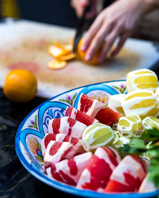 Woman peeling citrus fruit