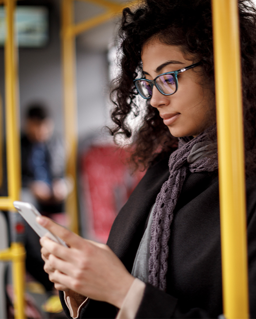 Woman checking her phone on the bus