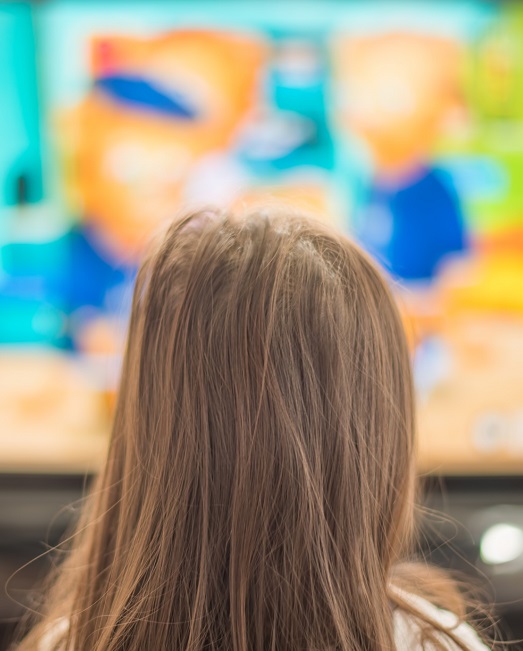 Young girl watching screen close up