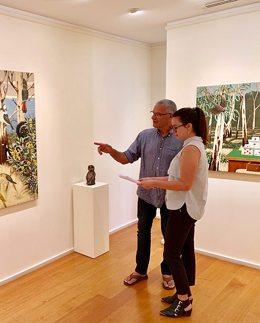 Jessica standing with artist Philip Davey in front of his exhibition.
