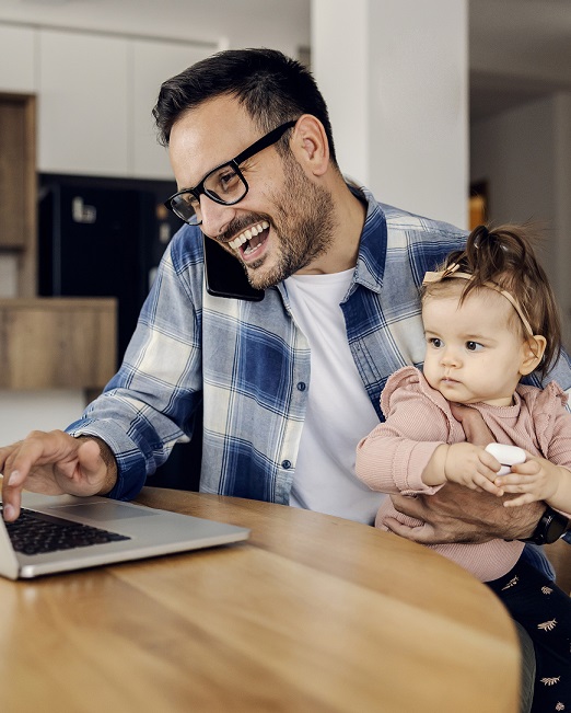 Father multitasking with young child