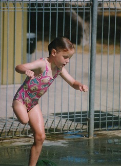 Young Ellie jumping into a pool