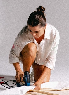 Taneal stapling a canvas to a frame