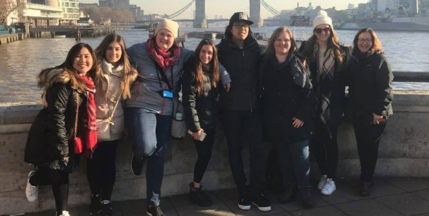 ACU students posing in front of the Tower Bridge, London