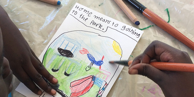 A student working on material for 'This is My Home'