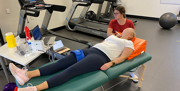 Courtney examining a pregnant woman after exercise