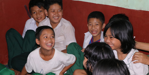Children enjoying a child club meeting, Myanmar.